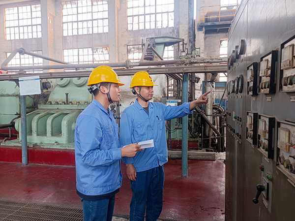 機組現(xiàn)場，老師傅正在向年輕員工傳授操作技藝.jpg